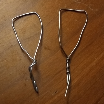 Two bent and twisted paperclips